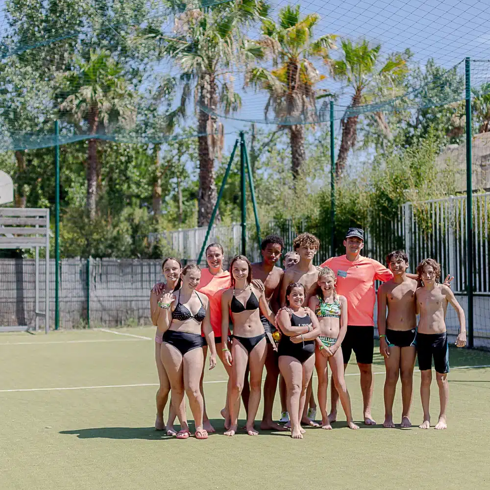 Groupe en maillots sur terrain de sport extérieur.